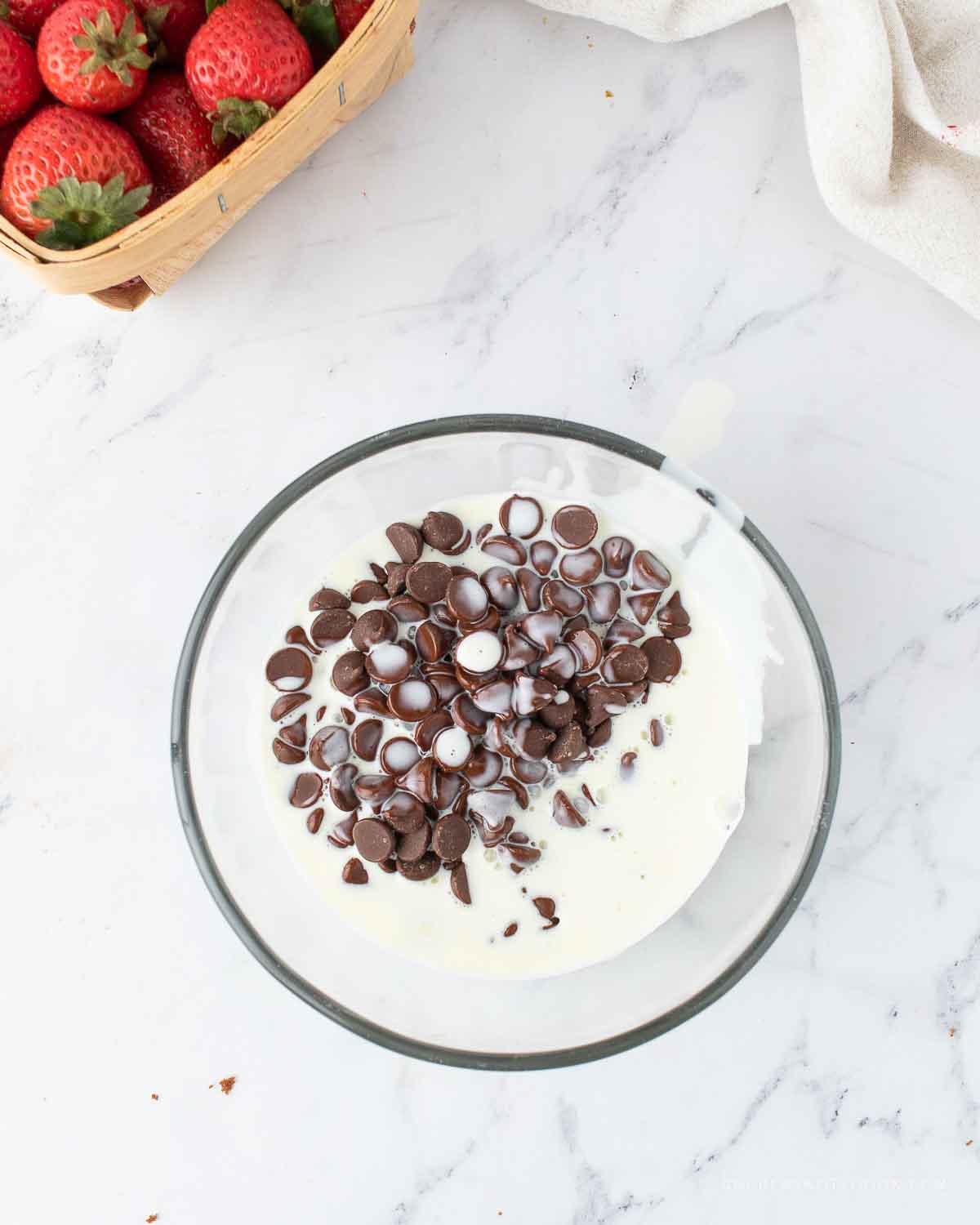 Cream and chocolate in a microwave safe bowl.