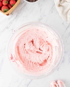 Strawberry frosting in a bowl.