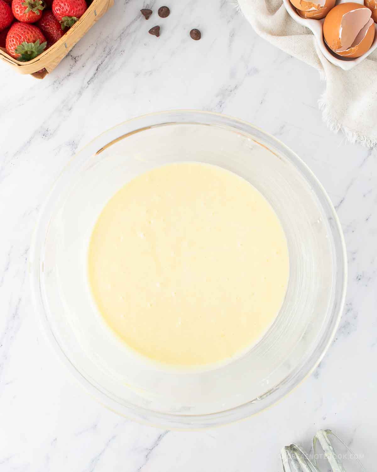 Eggs blended into the creamed sugar in a bowl.