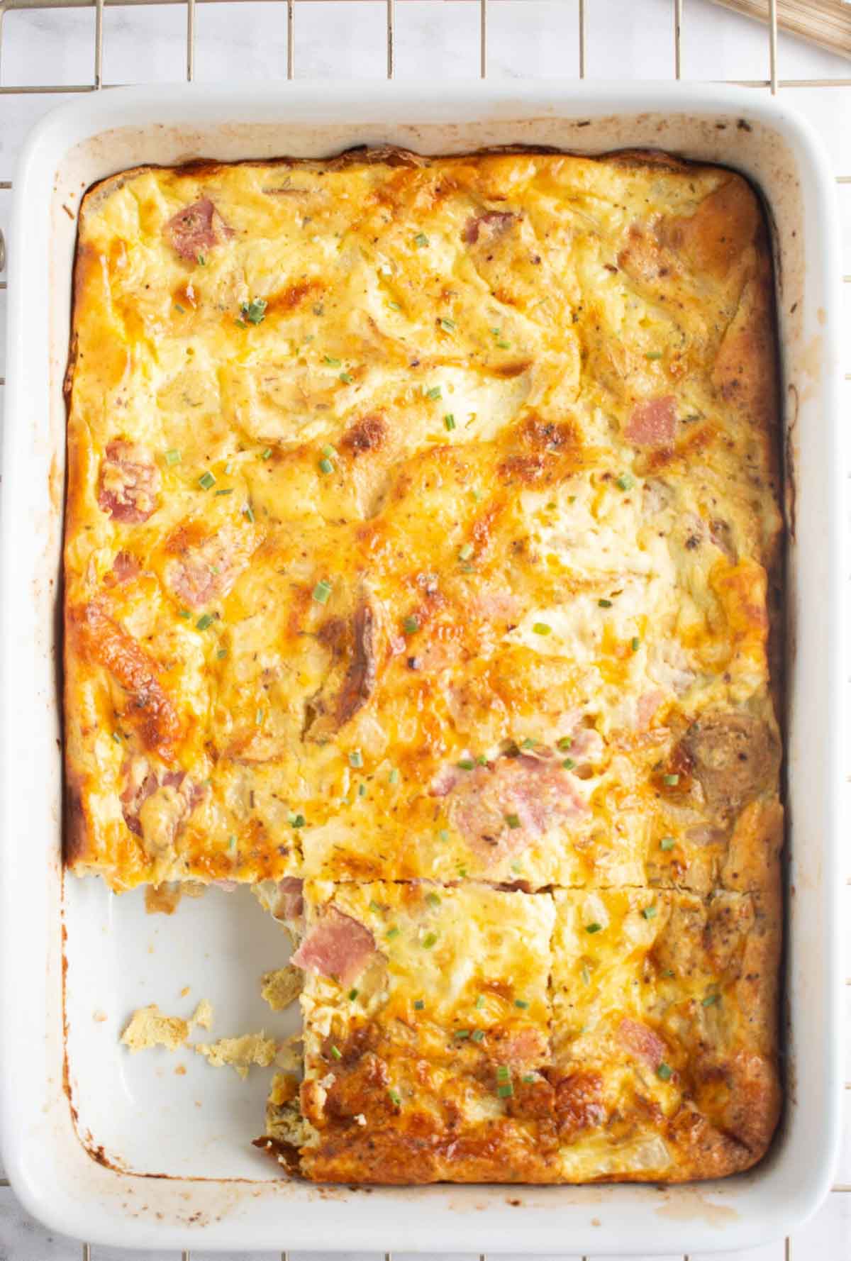 Boxed scalloped potatoes breakfast casserole with one square missing.