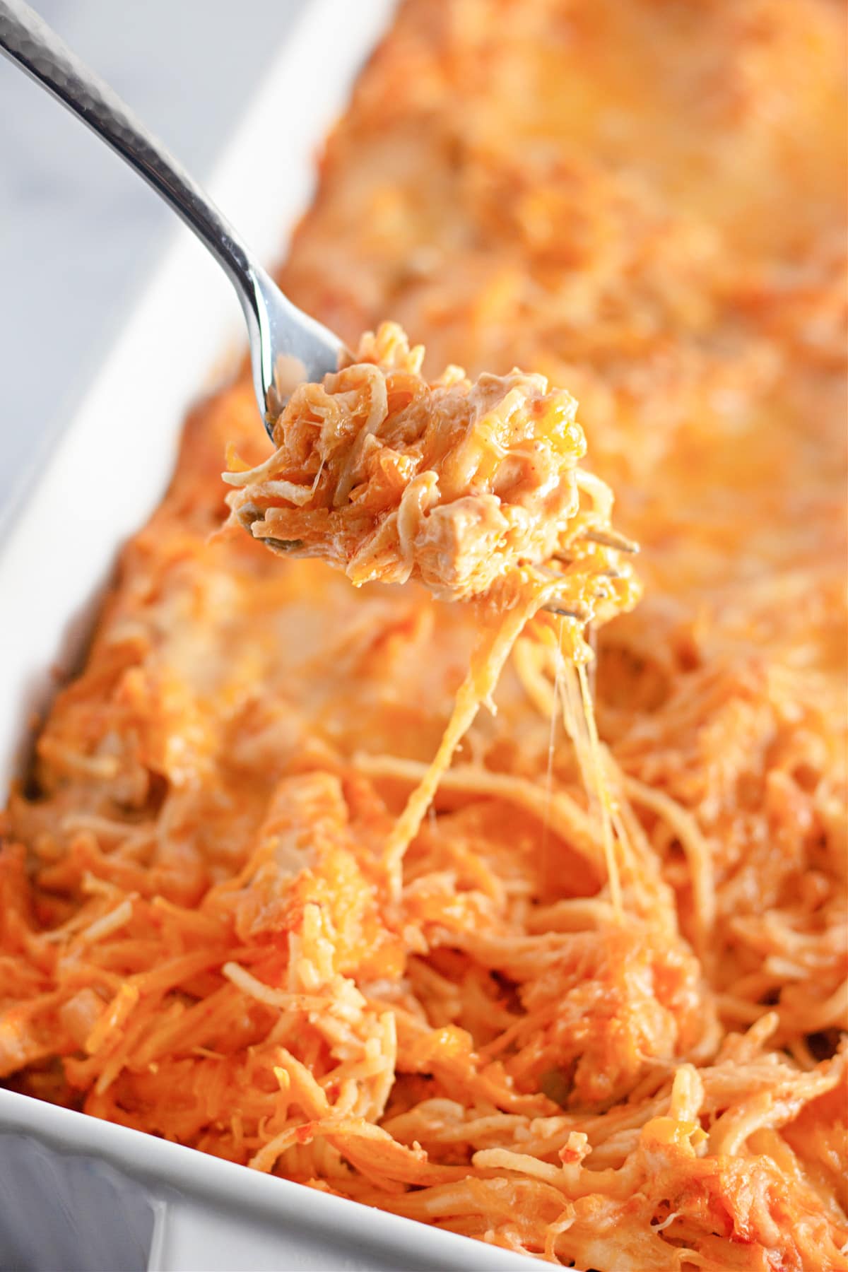 Mexican chicken spaghetti baked in a casserole dish.
