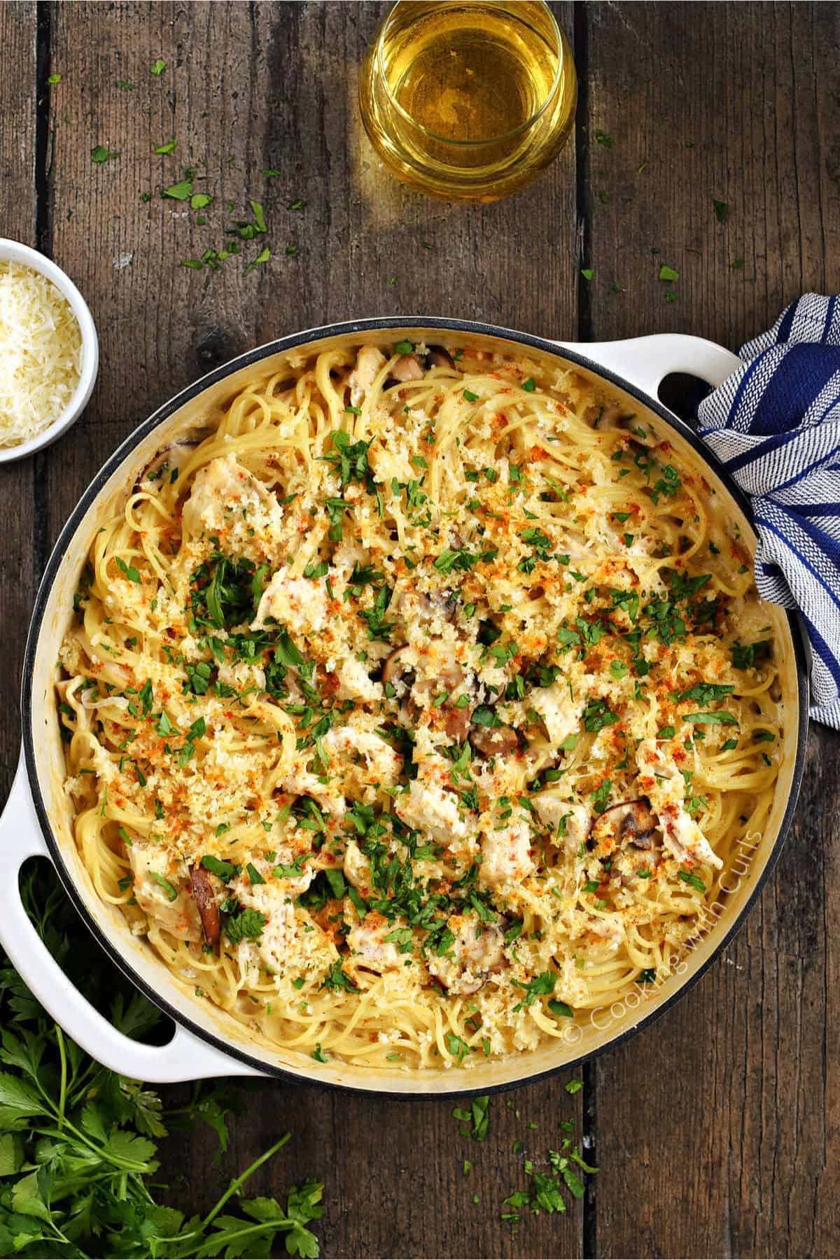 Large skillet full of spaghetti tetrazzini with chicken.
